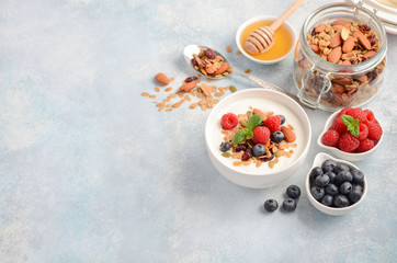 Homemade granola with yogurt and fresh berries, healthy breakfast concept, selective focus, copy space.
