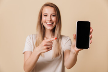 Portrait of a pretty casual girl pointing finger