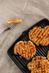 flat breads with cheese, onion and garlic on the grill