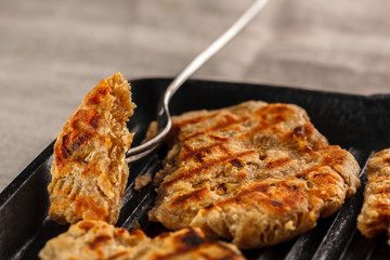 flat breads with cheese, onion and garlic on the grill
