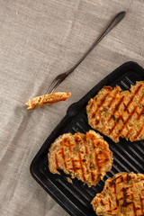 flat breads with cheese, onion and garlic on the grill