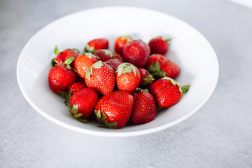 Top of view fresh strawberry in white plate in kitchen