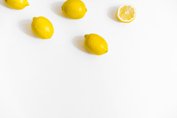 A few lemons on white background. Flat lay, top view. Copy space, header for blog 
