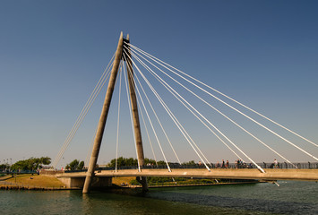Fototapeta na wymiar Cable bridge across the river