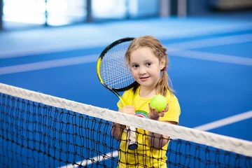 Foto op Plexiglas Child playing tennis on indoor court © famveldman