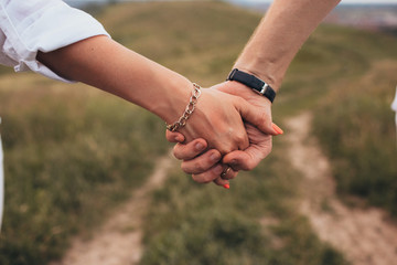 Close up shot of couple holding hands