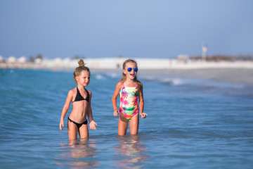 Cute happy children playing in the sea.