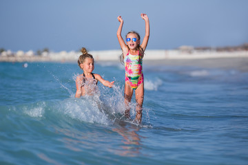 Cute happy children playing in the sea. Girlfriends splashing in the sea.