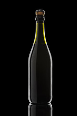 a bottle of sparkling wine on a black