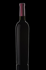 a bottle of wine on a black