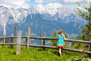 Fototapeta na wymiar Children hiking in Alps mountains. Kids outdoor.