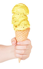 Ice cream in a cone waffle. Isolated on white background. Lemon ice cream. Ice cream in hand.