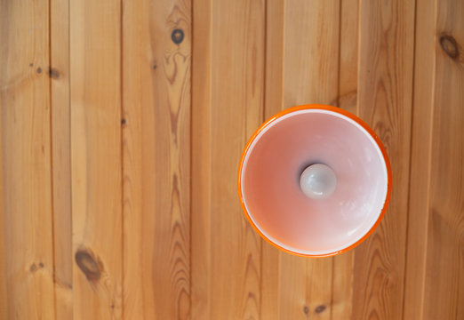 Orange ceiling  lamp on wooden background