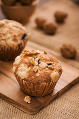 Tasty homemade walnut muffins on table. Sweet pastries