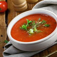 Gazpacho and ingredients on a table, vegetable soup. Delicious Spanish vegan cuisine.