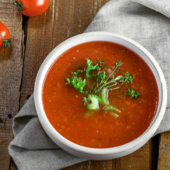 Traditional Spanish gazpacho on a rustic table. Delicious vegan cold tomato soup.