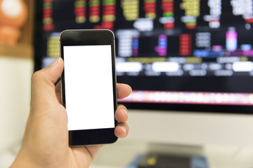 hand holding smart phone  with the stock market background