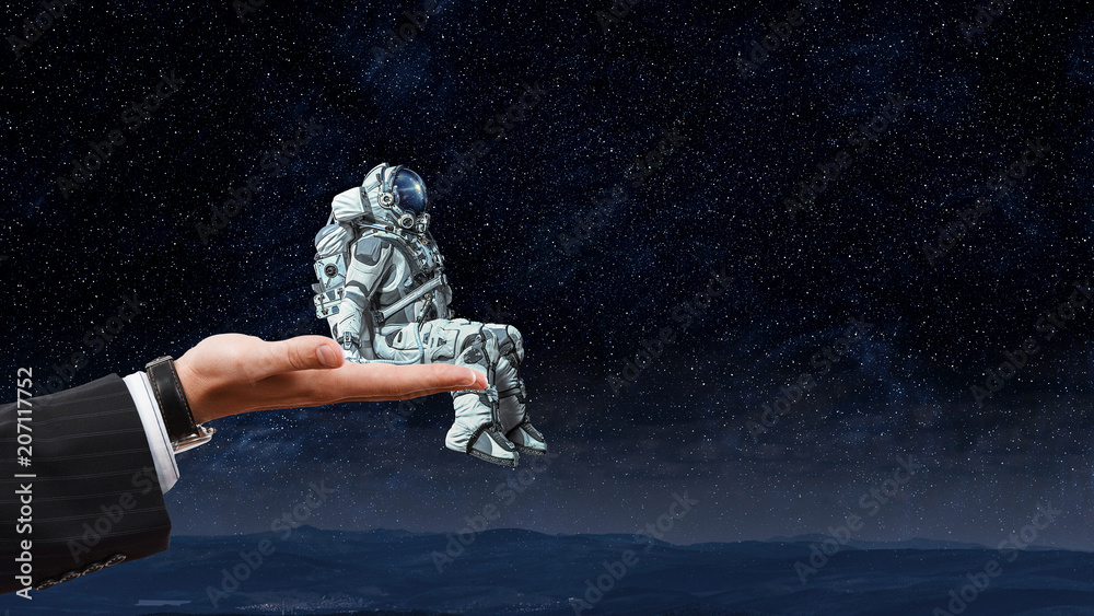 Wall mural spaceman on finger. mixed media