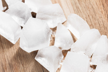 Ice cubes on wooden background