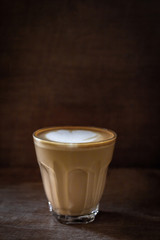 cup of hot coffee with foam and smoke on table in the morning. copyspace for your text