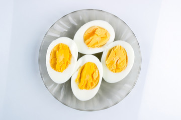 boiled eggs cut in half on a plate, breakfast, top view