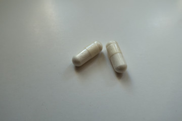 Simple white capsules of magnesium citrate (two items)