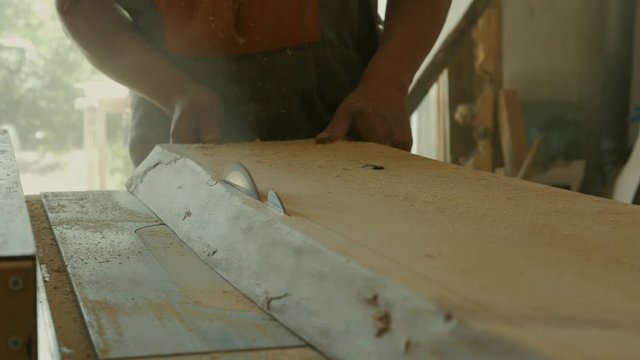 woodworker rip cut saws ash plank on a table saw. joiner. carpenter. 4k
