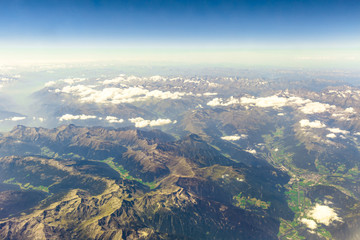 Scenic flight on Alps mountain range in Italy. Aerial view of Alpi mountains.