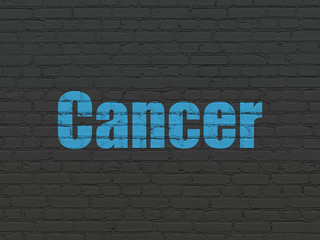 Fototapeta premium Health concept: Painted blue text Cancer on Black Brick wall background