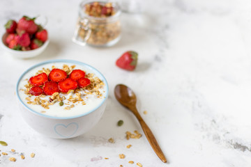 Fototapeta na wymiar Granola with yogurt and strawberry, healthy breakfast