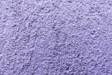 Purple paint textured plaster gunge wall.