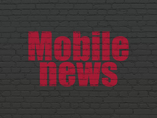 News concept: Painted red text Mobile News on Black Brick wall background