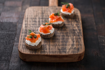 Mini catering sandwiches with cream cheese, smoked salmon, capers and dill.
