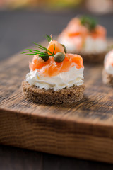 Mini catering sandwiches with cream cheese, smoked salmon, capers and dill.