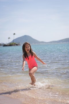 Girl playing in the water at beach
