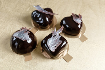 Delicious chocolates cakes. Glossy glaze and chocolate decor. Four different forms. dessert pie for sale at the shop.