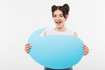 Portrait closeup of beautiful brunette woman 20s with double buns hairstyle holding empty advertising bubble for copyspace text, isolated over white background