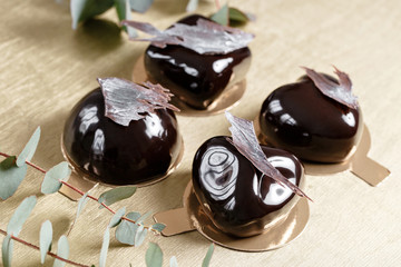Delicious chocolates cakes. Glossy glaze and chocolate decor. Four different forms. dessert pie for sale at the shop.