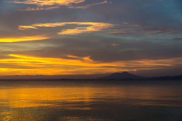 Fototapeta na wymiar Golden sunset on the beach of the island of Ometepe.