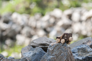 SUV toy car in nature / Wooden SUV, toy car in an extreme landscape.