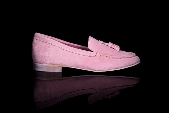 Women pink loafer shoe on black background with reflection. Fashion advertising shoes photos.