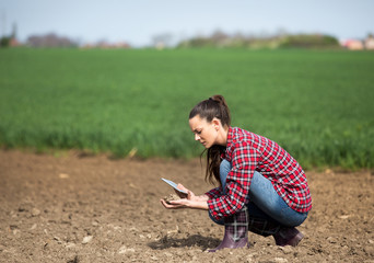 Farmer woman checking soil quality