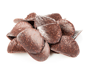 Chocolate chips close-up isolated on white background.