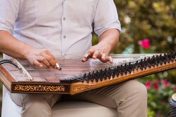 playing an Arabic stringed musical instrument