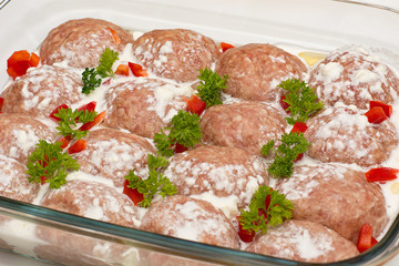 Meat minced red with aromatic seasonings on a white background.