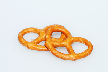 Delicious, crispy salty pretzels on a white background.