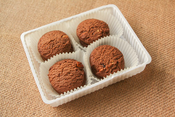 Chocolate chip cookies on brown background.