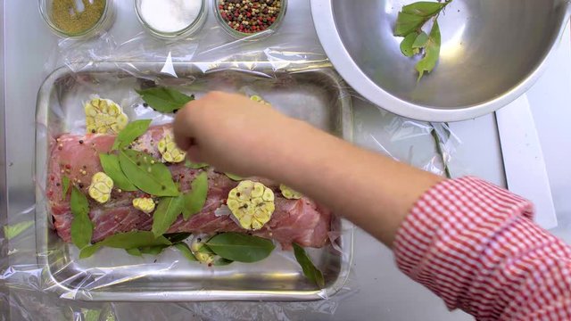 The chief is wrapping the meat in a baking sleeve