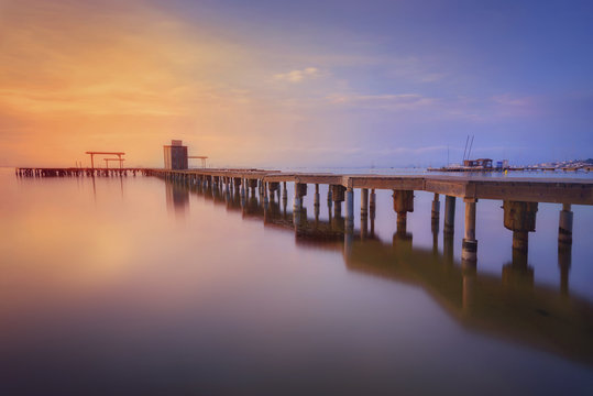 Spain, La Manga del Mar Menor, pier at sunrise