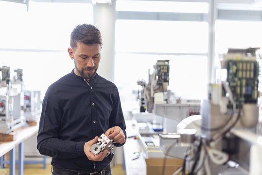 Man in factory examining product